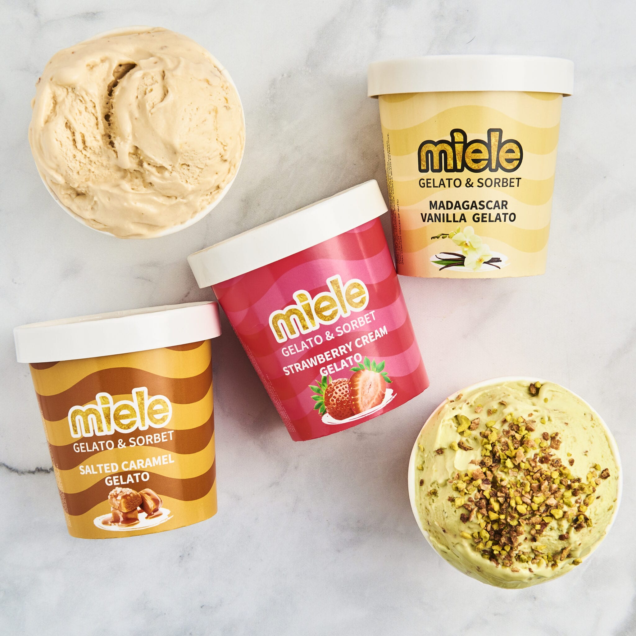 three pints of miele next to two bowls of gelato